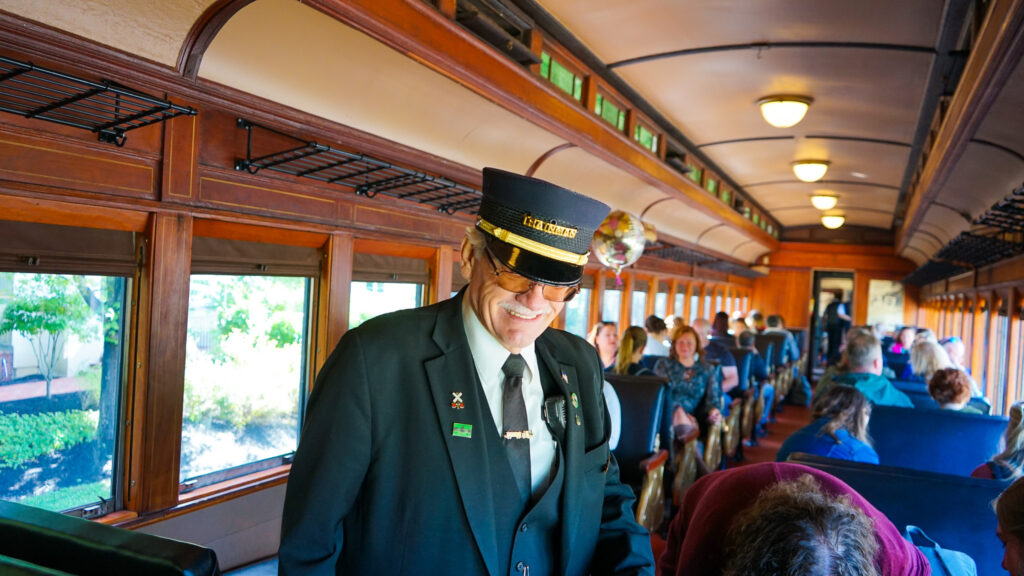 Hunterdon Wine Express Train Conductor talking with guests on the historic steam engine train