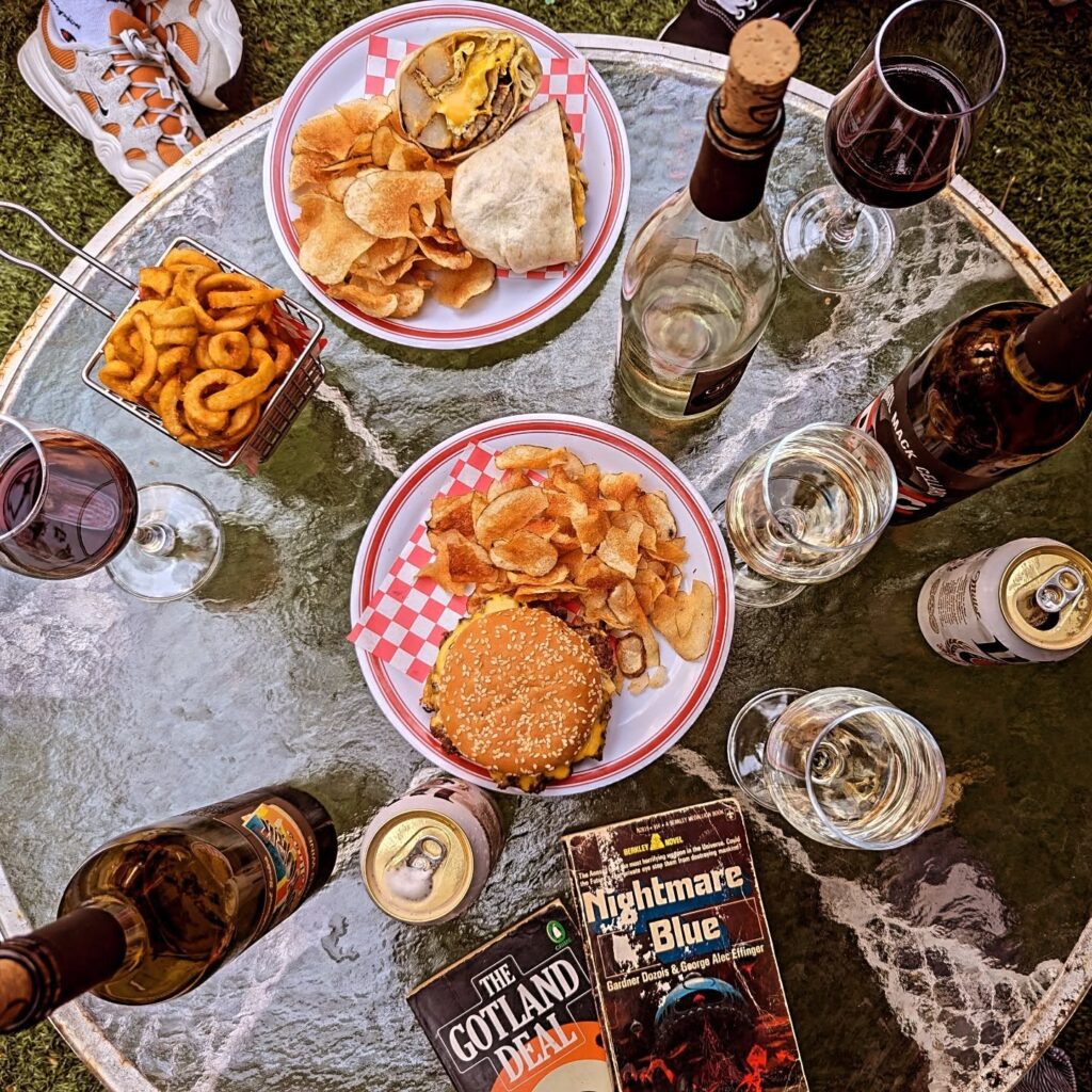 An overhead view of a table set at Uncle Rocco's Hoboken with snacks, wine glasses, and bottles of Old York Cellars wine, showing how the wines pair beautifully with casual dining.