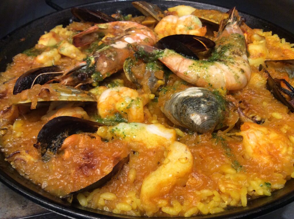 Seafood paella prepared by Chef José Diaz at Old York Cellars Winery in Ringoes, Hunterdon County, NJ, featuring shrimp, mussels, and calamari in a saffron‑infused sauce.