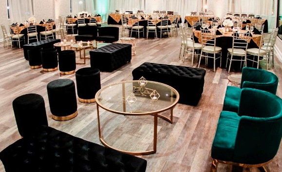 Contemporary lounge area with black cushioned seating and round glass tables arranged for casual dining at AARZU Modern Bistro.