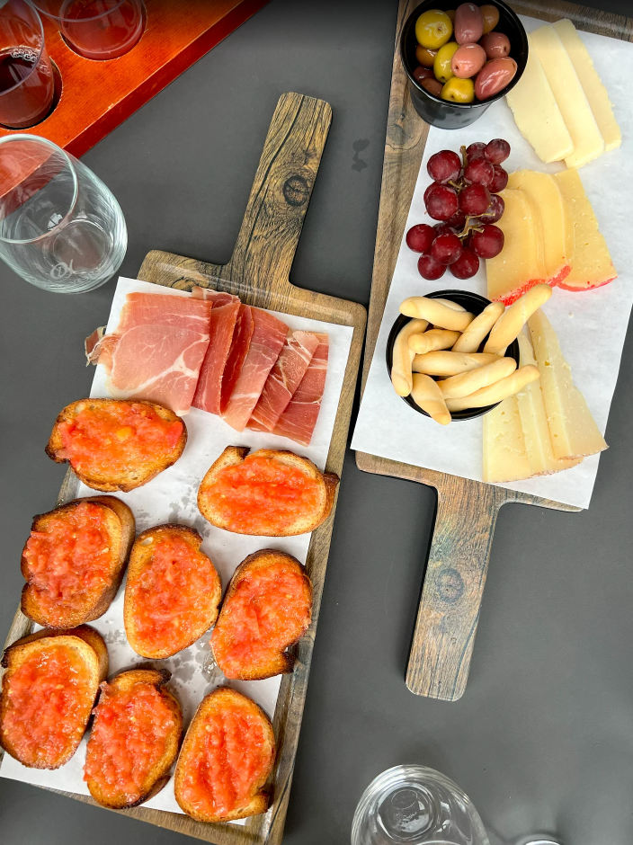 Charcuterie Boards. Two wood boards with sliced meats, cheeses, and grapes served at Old York Cellars.
