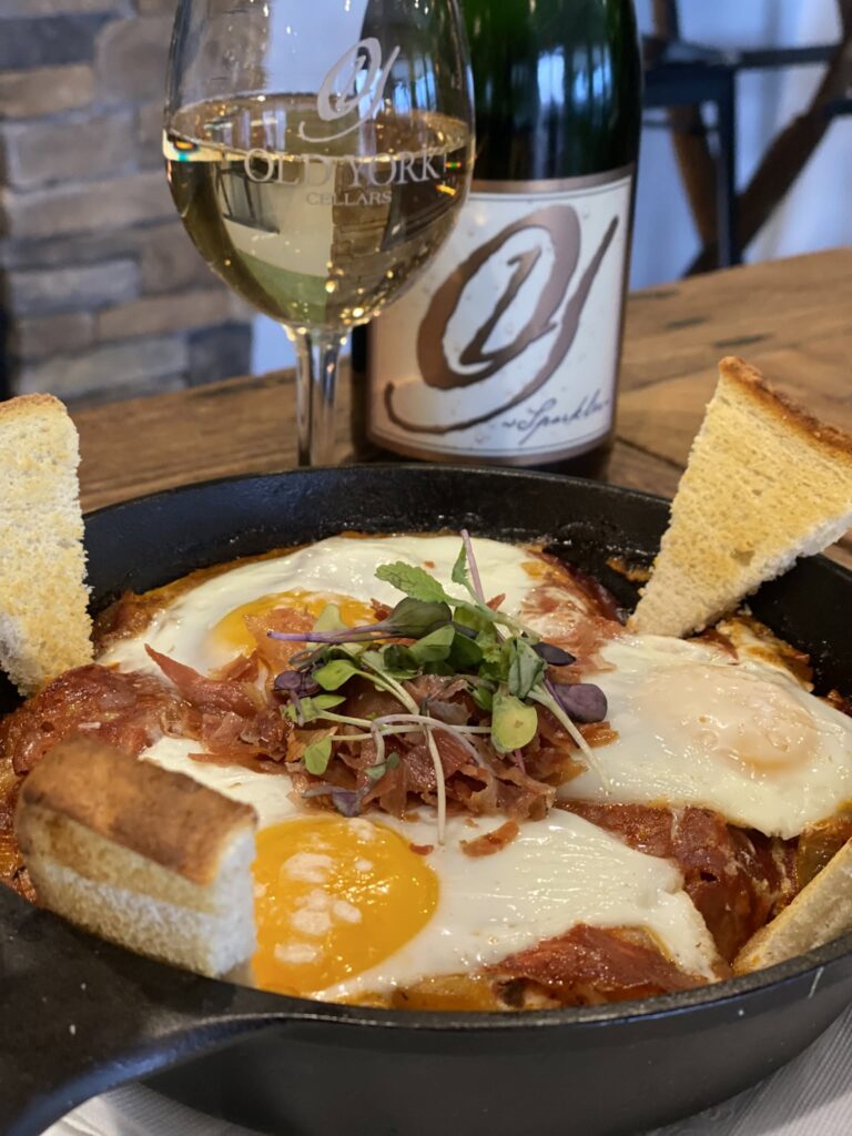 Weekend Bubbly Brunch at Old York Cellars in Ringoes, Hunterdon County, NJ, featuring a table set with mimosas, sparkling wine, and Spanish‑inspired brunch dishes overlooking the vineyard.
