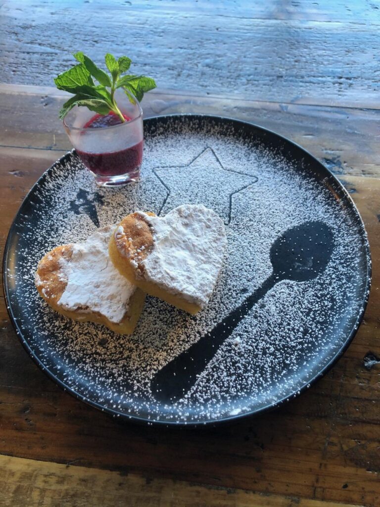 Dessert by Chef José Diaz at Old York Cellars Winery in Ringoes, Hunterdon County, NJ—powdered‑sugar pastries with a layered berry parfait and fresh mint garnish on a star‑patterned plate.