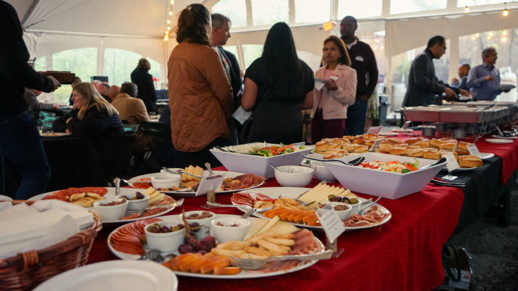Buffet table at a private event under the vineyard tent at Old York Cellars in Ringoes, Central NJ, featuring Chef José Diaz’s catered appetizers and hors d’oeuvres as guests socialize nearby.