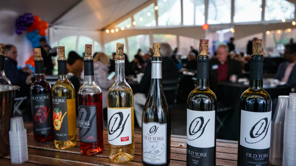 Display of Old York Cellars wines at a private event Central NJ, with bottles arranged on a table and guests enjoying the tasting experience in the background.