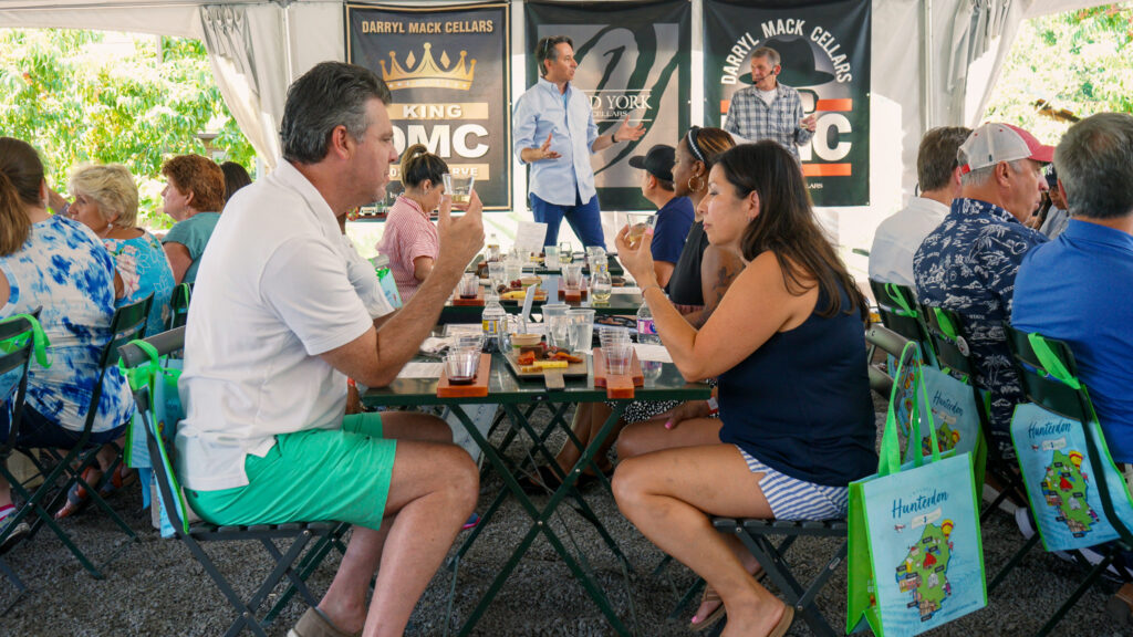 Couples and friends enjoying lunch at Old York Cellars in Ringoes, Central NJ, during a Hunterdon Wine Express experience under the vineyard tent.