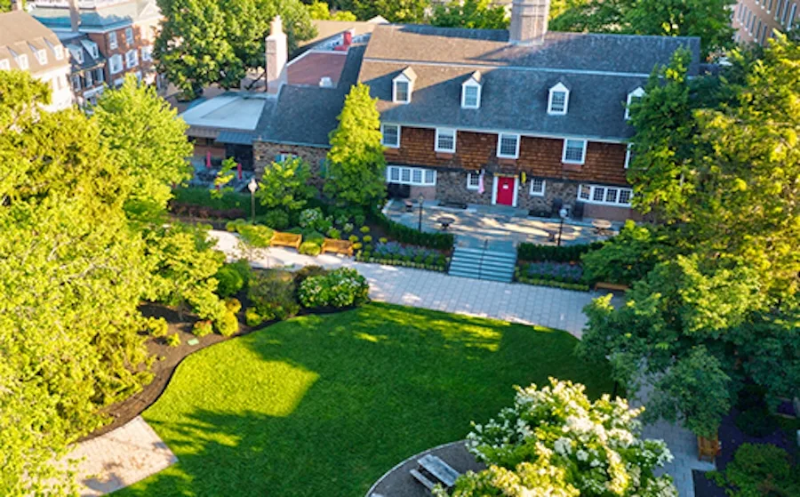 Aerial view of Nassau Inn in downtown Princeton, New Jersey, surrounded by trees and walkways with its classic brick façade and slate roof.