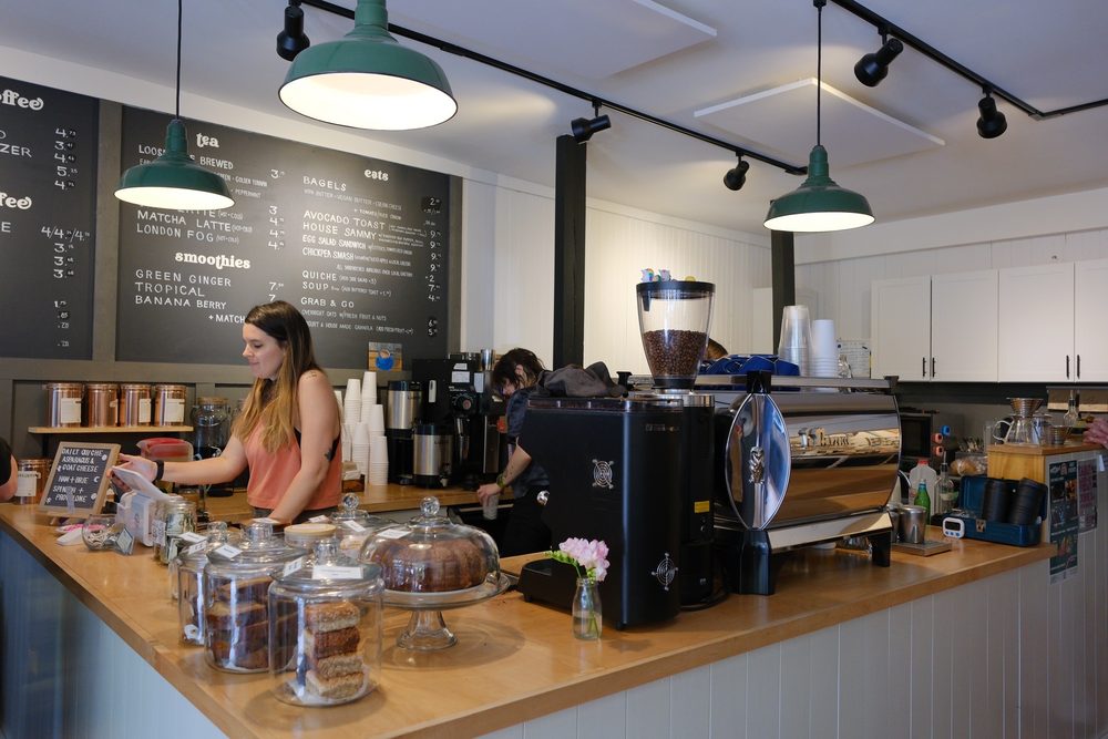 Coffee bar with espresso machine, pastries under glass domes, and industrial lighting at Union Coffee in Lambertville.