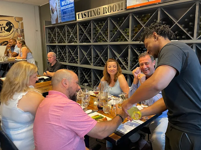 Guests seated inside the Old York Cellars Vista Room sharing food and wine.