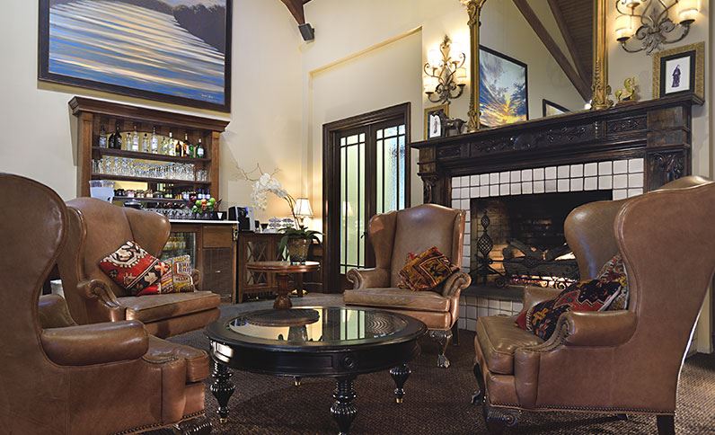 Interior lounge at Lambertville Station Restaurant and Inn featuring leather seating, a fireplace, and elegant décor with warm lighting and river‑town charm.