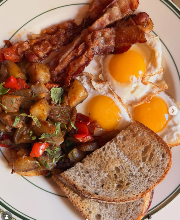 Classic breakfast plate with eggs, bacon, home fries, and toast served at Uncle Rocco in Hoboken, NJ.