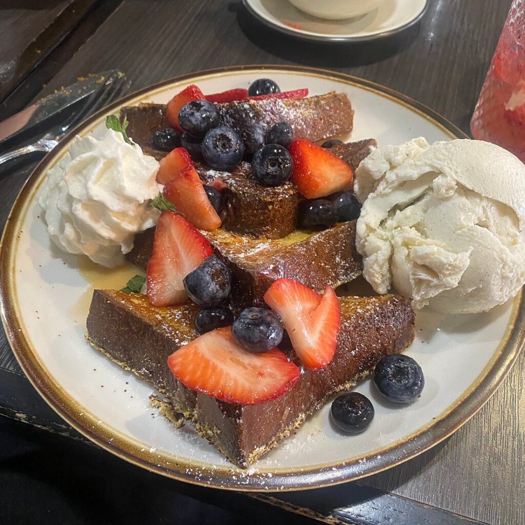 French toast topped with fresh strawberries, blueberries, and whipped cream at Brunch by De Martino in Somerville, NJ.